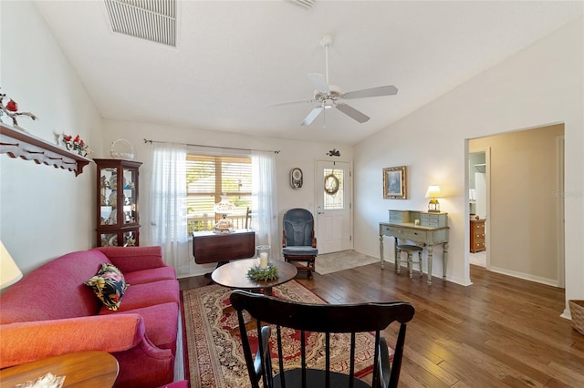 living room with ceiling fan, lofted ceiling, and hardwood / wood-style floors