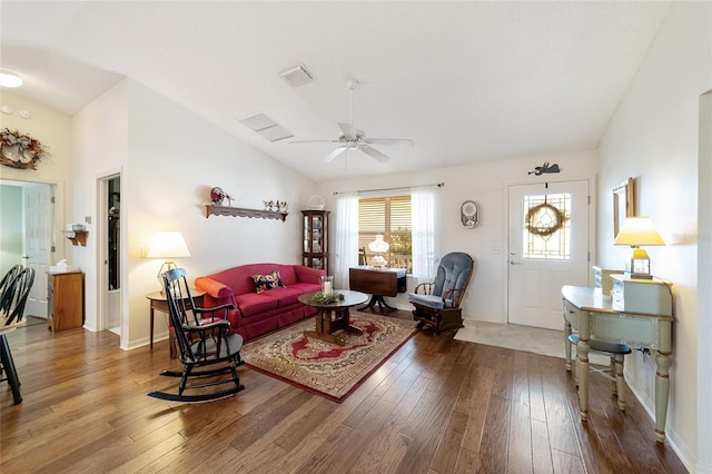 living area featuring lofted ceiling, visible vents, ceiling fan, and wood finished floors