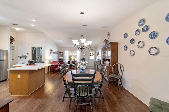 dining space with an inviting chandelier, dark hardwood / wood-style flooring, and lofted ceiling