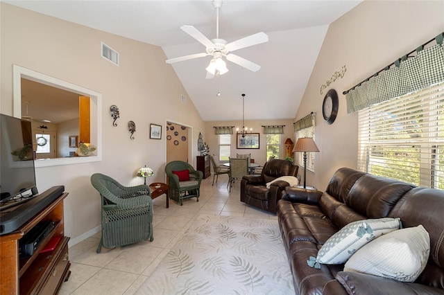 living room with light tile patterned floors, visible vents, high vaulted ceiling, and ceiling fan with notable chandelier