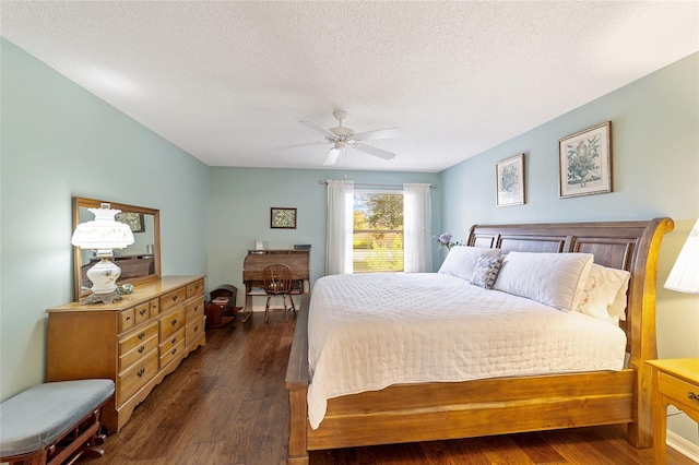 bedroom with a textured ceiling, ceiling fan, and dark hardwood / wood-style flooring