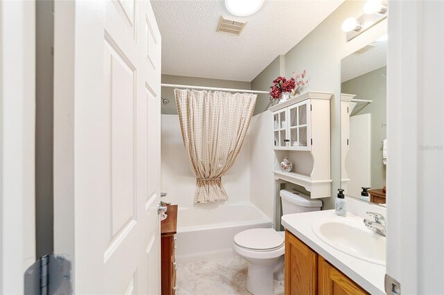 full bathroom featuring toilet, vanity, tile patterned floors, a textured ceiling, and shower / tub combo with curtain