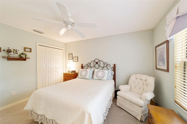 bedroom featuring ceiling fan, a closet, and carpet flooring