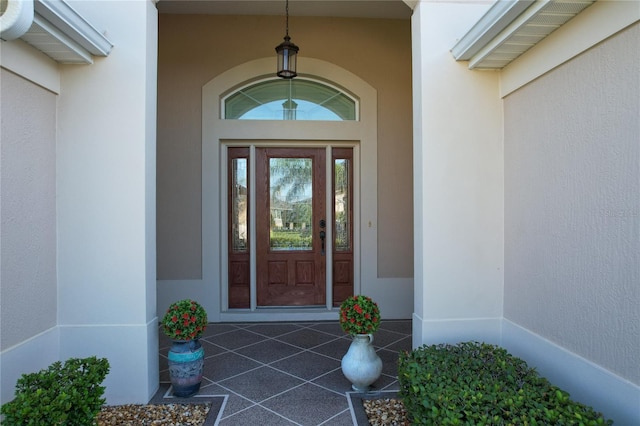 doorway to property with stucco siding