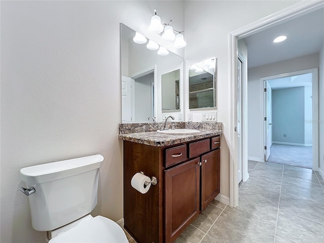 full bathroom featuring baseboards, vanity, and toilet