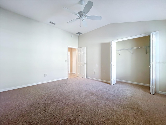 unfurnished bedroom featuring carpet floors, a closet, vaulted ceiling, and baseboards