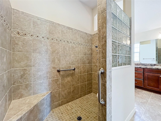 full bath with a walk in shower, tile patterned flooring, and vanity