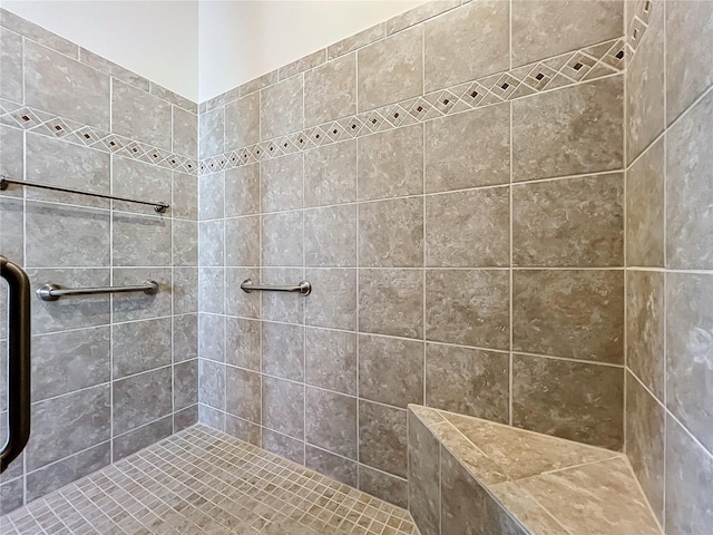 bathroom with a tile shower