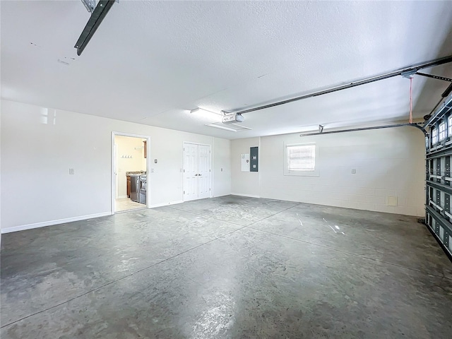 garage featuring a garage door opener, concrete block wall, and electric panel