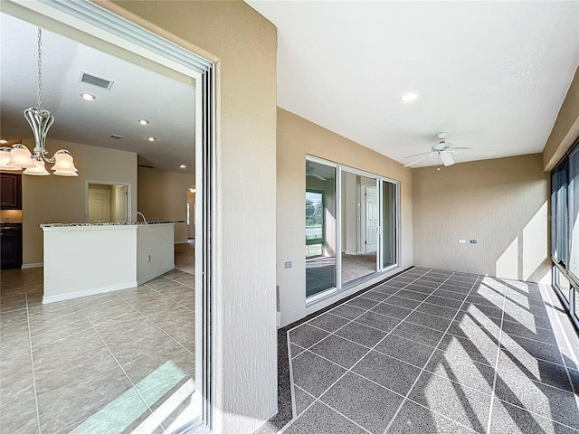 interior space featuring a patio, visible vents, and a ceiling fan