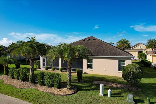 exterior space featuring roof with shingles, a lawn, and stucco siding