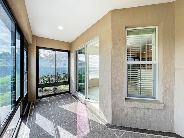 1338 Neuport Path, The Villages, FL 32163 - unfurnished sunroom featuring a textured wall, granite floors, and recessed lighting