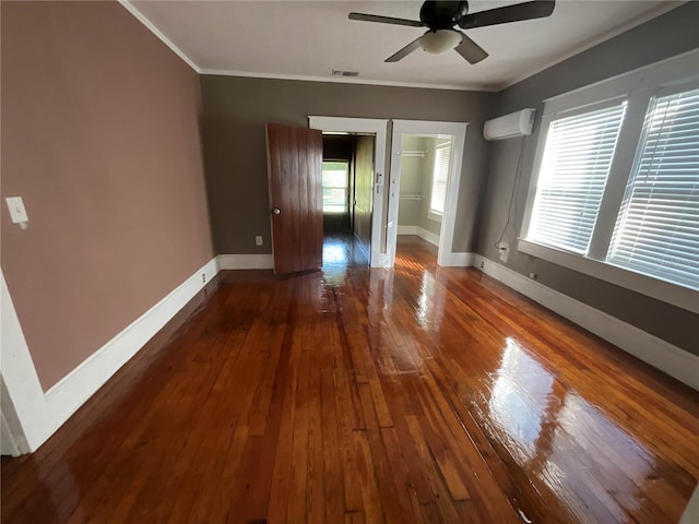 spare room featuring dark wood-type flooring, a wealth of natural light, and ceiling fan