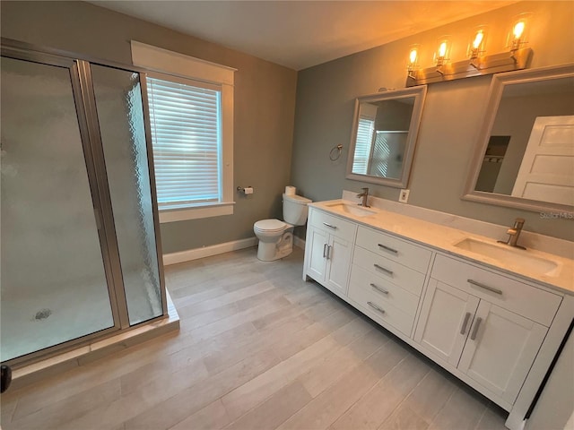 bathroom with vanity, toilet, plenty of natural light, and walk in shower