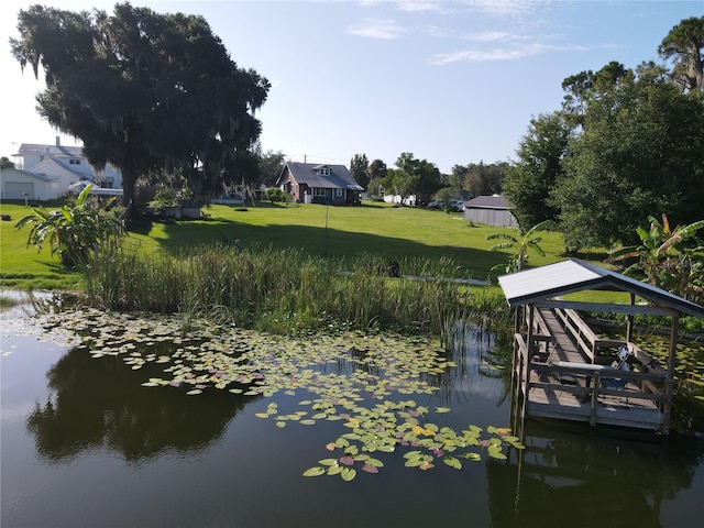 dock area featuring a water view and a yard