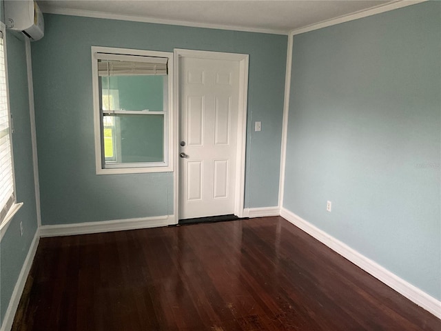 unfurnished room featuring a wall mounted AC, ornamental molding, and dark wood-type flooring