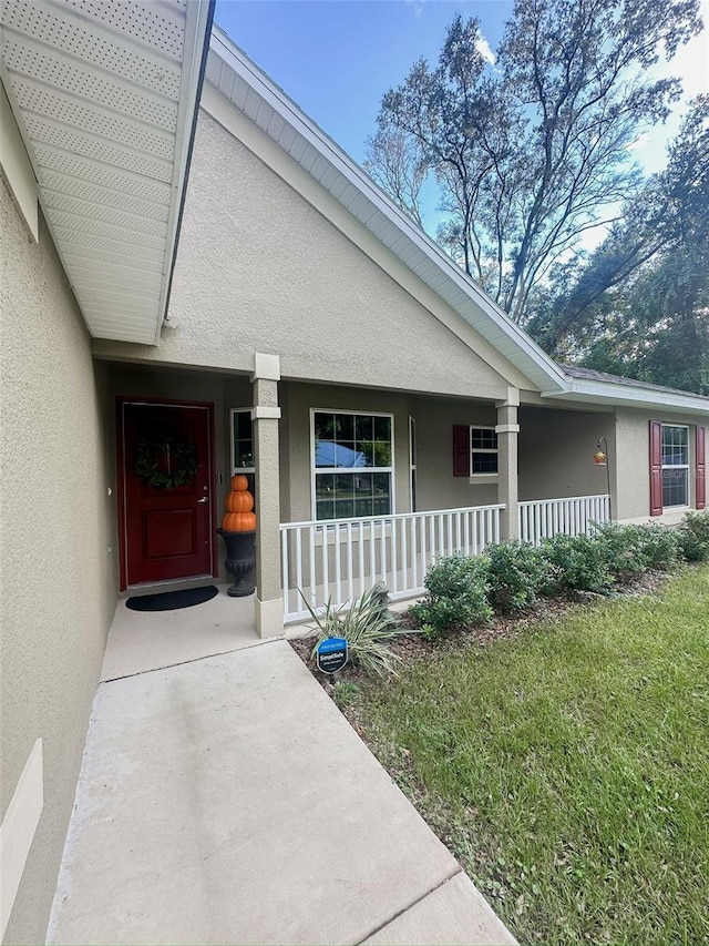 property entrance featuring covered porch