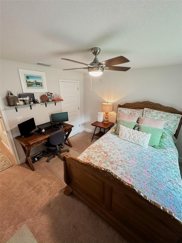 bedroom featuring ceiling fan, a textured ceiling, and carpet flooring