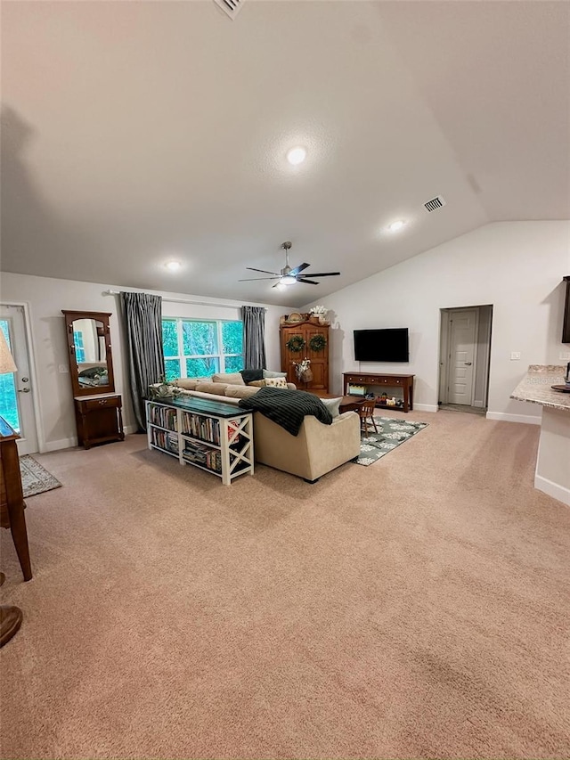 carpeted living room with ceiling fan and lofted ceiling