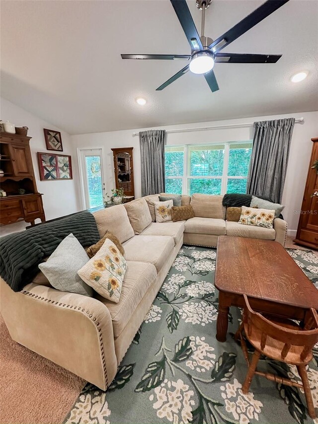 living room featuring vaulted ceiling and ceiling fan