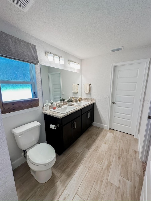 bathroom featuring hardwood / wood-style floors and a textured ceiling