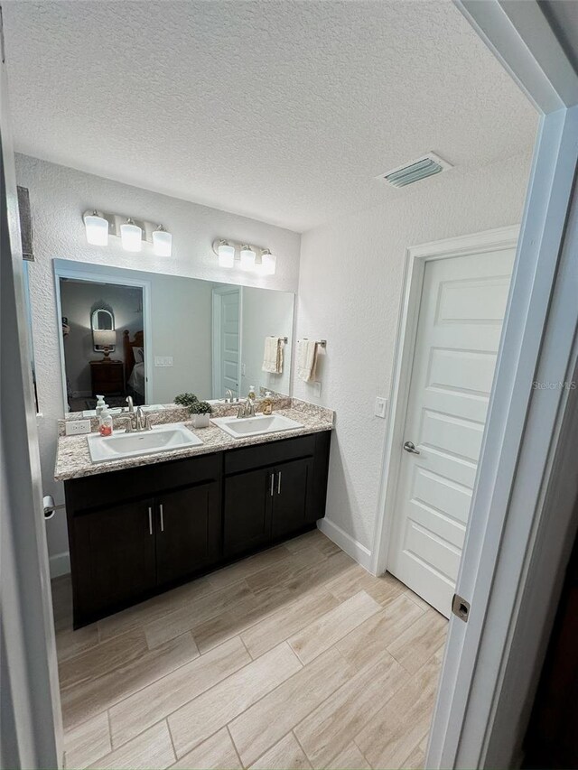 bathroom featuring vanity and a textured ceiling