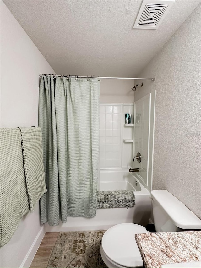 full bathroom featuring toilet, shower / tub combo, a textured ceiling, vanity, and hardwood / wood-style floors