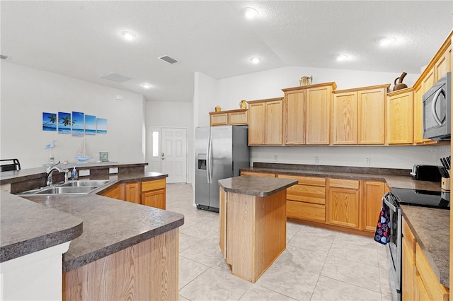 kitchen featuring light tile patterned flooring, appliances with stainless steel finishes, sink, vaulted ceiling, and a kitchen island