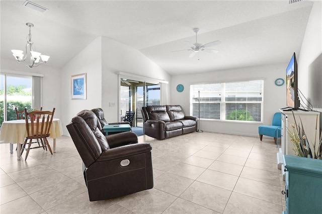 tiled living room featuring ceiling fan with notable chandelier, vaulted ceiling, and a wealth of natural light