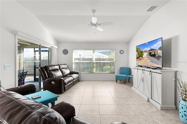 tiled living room featuring ceiling fan and lofted ceiling