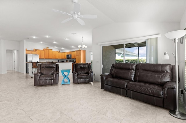 tiled living room featuring ceiling fan with notable chandelier and vaulted ceiling