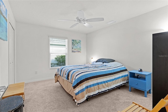 carpeted bedroom with a closet and ceiling fan