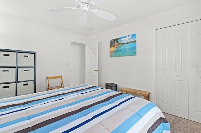 carpeted bedroom with ceiling fan and a closet