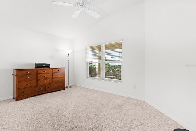 unfurnished bedroom featuring ceiling fan, vaulted ceiling, and light colored carpet