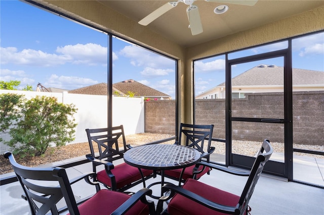 sunroom featuring ceiling fan