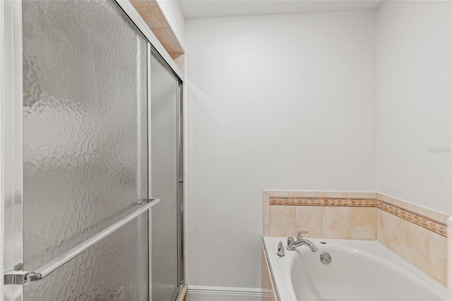 bathroom featuring separate shower and tub