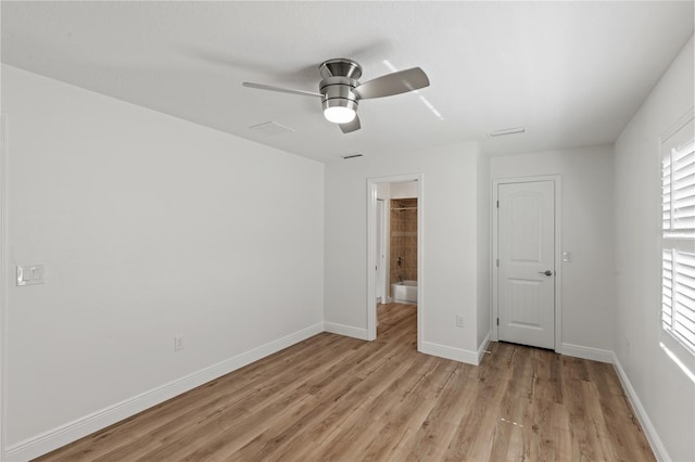 unfurnished bedroom featuring light hardwood / wood-style floors, ceiling fan, and ensuite bath