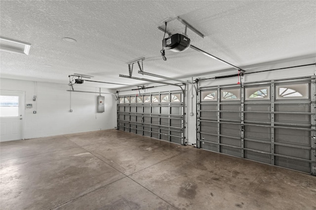 garage featuring electric panel and a garage door opener