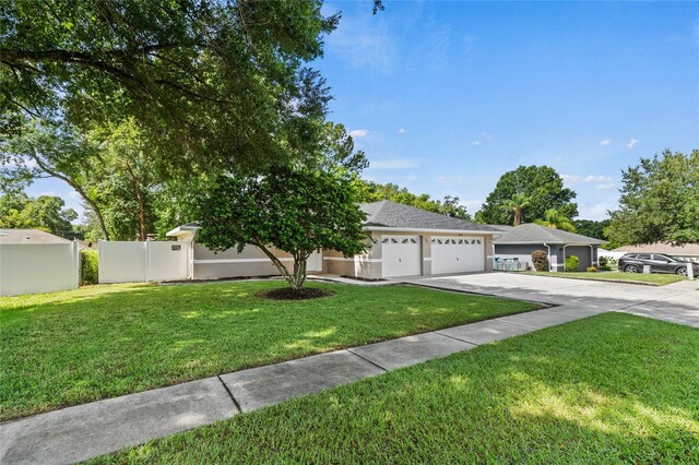 ranch-style home with a garage and a front yard