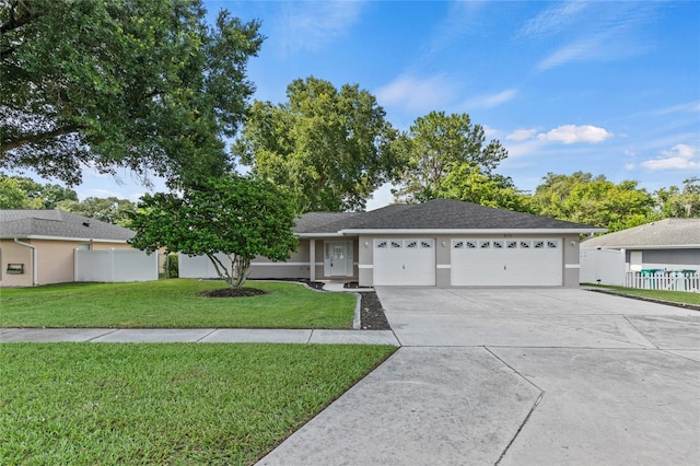 single story home featuring a garage and a front yard