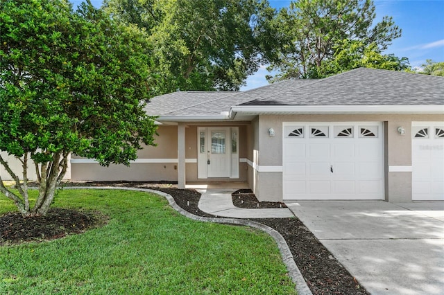 ranch-style home with a garage and a front lawn