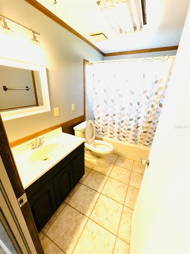 full bathroom featuring shower / bath combination with curtain, vanity, toilet, crown molding, and tile patterned floors