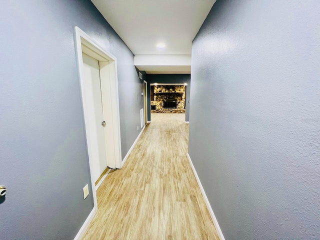 hallway with hardwood / wood-style floors