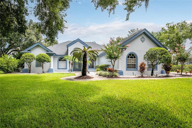 single story home featuring a front lawn