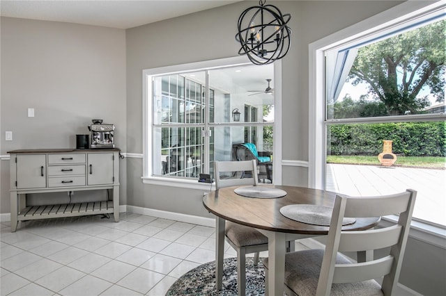 dining area with ceiling fan with notable chandelier and light tile patterned flooring