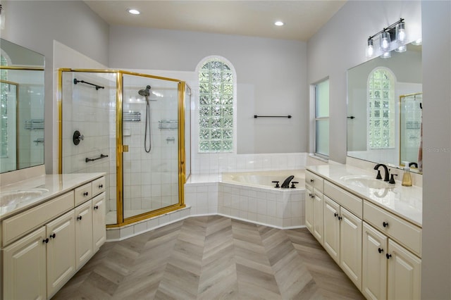 bathroom with parquet floors, plus walk in shower, and double sink vanity