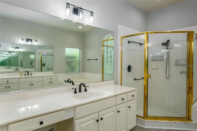 bathroom featuring vanity and a shower with door