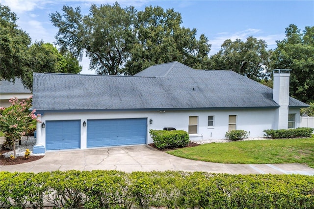 view of front facade with a garage and a front yard