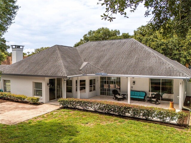 exterior space featuring a lawn and a patio area