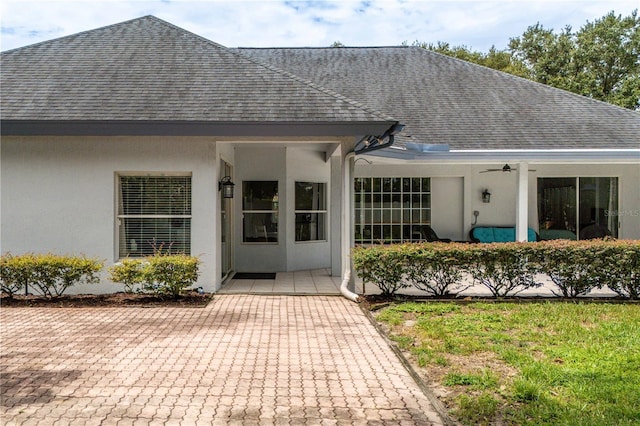 back of house with ceiling fan and a patio area